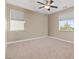 This empty bedroom features a ceiling fan, neutral walls, with carpet and a window with natural light at 4212 Hawks Glide Ave, North Las Vegas, NV 89084
