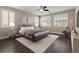 Bedroom featuring large windows with shutters, ceiling fan, and a comfortable layout at 4212 Hawks Glide Ave, North Las Vegas, NV 89084