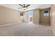 Large bedroom with ceiling fan and balcony access offers an airy and relaxing space at 4212 Hawks Glide Ave, North Las Vegas, NV 89084