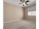 Neutral bedroom with a ceiling fan, a window providing natural light, and carpet flooring at 4212 Hawks Glide Ave, North Las Vegas, NV 89084