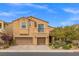 Charming two-story home featuring stucco siding, a balcony, three-car garage, and neatly landscaped yard at 4212 Hawks Glide Ave, North Las Vegas, NV 89084