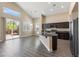 Bright kitchen features a sliding glass door for natural light, island with seating, and ample cabinetry at 4212 Hawks Glide Ave, North Las Vegas, NV 89084