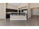 Open kitchen with dark wood cabinets, granite counters, and a large island for seating at 4212 Hawks Glide Ave, North Las Vegas, NV 89084