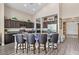 Spacious kitchen boasts dark cabinets, granite counters, and seating at the island at 4212 Hawks Glide Ave, North Las Vegas, NV 89084