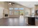 Open-concept living room featuring vaulted ceilings, fireplace, bar seating, and sliding glass doors at 4212 Hawks Glide Ave, North Las Vegas, NV 89084