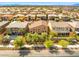 Wide shot of houses in the neighborhood with manicured trees and a swimming pool at 4212 Hawks Glide Ave, North Las Vegas, NV 89084