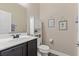 Cozy powder room with dark wood cabinets, stylish mirror, and decor at 4212 Hawks Glide Ave, North Las Vegas, NV 89084