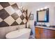 Elegant bathroom featuring a soaking tub, granite counters, and stylish black and white decor at 4525 Dean Martin Dr # 1103, Las Vegas, NV 89103