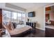Bedroom featuring city views from large window, a TV, and dark hardwood floors at 4525 Dean Martin Dr # 1103, Las Vegas, NV 89103