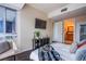 Comfortable bedroom featuring city views from a large window and a TV mounted on the wall at 4525 Dean Martin Dr # 1103, Las Vegas, NV 89103