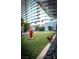Well-maintained dog park with a fire hydrant and condo building in the background at 4525 Dean Martin Dr # 1103, Las Vegas, NV 89103