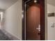 Apartment 1103 featuring a hardwood door, modern lighting, and a carpeted hallway at 4525 Dean Martin Dr # 1103, Las Vegas, NV 89103