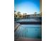 Resort-style swimming pool and hot tub with glass railing and palm trees at 4525 Dean Martin Dr # 1103, Las Vegas, NV 89103