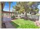 Backyard with lawn, a covered patio, mature trees, and privacy wall at 731 Rising Star Dr, Henderson, NV 89014
