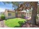 Spacious backyard with lawn area, mature trees, and patio at 731 Rising Star Dr, Henderson, NV 89014