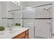 Tiled bathroom with a modern vanity, framed mirror, and glass door shower at 731 Rising Star Dr, Henderson, NV 89014