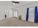 Sun-filled bedroom with plush carpeting and natural light from the sliding glass doors and large window at 731 Rising Star Dr, Henderson, NV 89014
