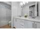 Modern bathroom featuring a double sink vanity, white cabinets, and a glass-enclosed shower at 8440 Footpath St, Las Vegas, NV 89166