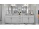 Elegant bathroom with dual sinks, large mirrors, and stylish white cabinetry at 8440 Footpath St, Las Vegas, NV 89166