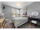 Inviting bedroom with large windows, a hanging chair, and modern decor at 8440 Footpath St, Las Vegas, NV 89166