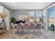 Dining area with modern table, chairs, large windows, and backyard views at 8440 Footpath St, Las Vegas, NV 89166