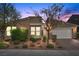 Charming single-story home featuring a stone facade, tile roof, desert landscaping, and an attached two-car garage at 8440 Footpath St, Las Vegas, NV 89166