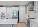 Modern kitchen featuring white cabinets, stainless steel appliances, and white countertops at 8440 Footpath St, Las Vegas, NV 89166