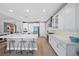 Bright kitchen features a large island with seating, modern appliances, and white cabinets at 8440 Footpath St, Las Vegas, NV 89166