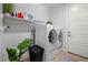 Functional laundry room with modern washer, dryer, and ample storage shelves at 8440 Footpath St, Las Vegas, NV 89166