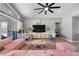 Bright living room features a ceiling fan, media center, and a large sliding door to the backyard at 8440 Footpath St, Las Vegas, NV 89166