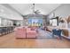 Inviting great room featuring vaulted ceilings, a stylish pink sectional, and views of the lush backyard at 8440 Footpath St, Las Vegas, NV 89166