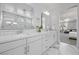 Elegant main bathroom showcasing a double vanity and a glimpse of the main bedroom at 8440 Footpath St, Las Vegas, NV 89166