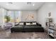 Main bedroom sitting area with a comfortable sofa and a decorative plant at 8440 Footpath St, Las Vegas, NV 89166