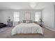 Bright main bedroom with a decorative chandelier and neutral color palette at 8440 Footpath St, Las Vegas, NV 89166