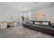 Main bedroom sitting area with a plush sofa, large windows and a decorative mirror at 8440 Footpath St, Las Vegas, NV 89166