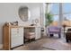 Main bedroom vanity featuring built-in storage and natural light from a large window at 8440 Footpath St, Las Vegas, NV 89166