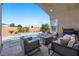 Inviting outdoor patio with a pool, fire pit, and comfortable seating area for relaxation at 8440 Footpath St, Las Vegas, NV 89166