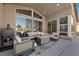 Covered patio featuring comfortable seating, a fire pit, and a grilling area, perfect for entertaining at 8440 Footpath St, Las Vegas, NV 89166