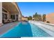 Backyard pool with water features, lounge chairs, and covered patio for ultimate relaxation at 8440 Footpath St, Las Vegas, NV 89166