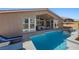 A luxurious outdoor pool and patio area with comfortable seating and a manicured landscape at 8440 Footpath St, Las Vegas, NV 89166