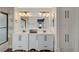 Bright bathroom boasts dual sinks, updated lighting, and ample cabinet space at 10809 Garden Mist Dr Dr # 2041, Las Vegas, NV 89135
