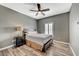 This comfortable bedroom has a ceiling fan, window with shutters, and a nightstand at 10809 Garden Mist Dr Dr # 2041, Las Vegas, NV 89135