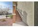 Exterior steps to upper-level entrance feature tan textured walls and decorative column at 10809 Garden Mist Dr Dr # 2041, Las Vegas, NV 89135