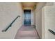 Inviting front entrance features a dark teal door, contrasted against the neutral, textured exterior walls at 10809 Garden Mist Dr Dr # 2041, Las Vegas, NV 89135