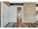 Entryway with exposed brick accent wall, hardwood floors, and direct view into other rooms at 10809 Garden Mist Dr Dr # 2041, Las Vegas, NV 89135