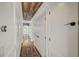 Hallway featuring hardwood floors, white walls, wood plank ceiling and access to rooms with storage space at 10809 Garden Mist Dr Dr # 2041, Las Vegas, NV 89135