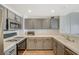 Well-lit kitchen featuring stainless steel appliances, gray cabinetry, white countertops, and gas cooktop at 10809 Garden Mist Dr Dr # 2041, Las Vegas, NV 89135