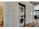 Laundry closet features stacked washer and dryer, with easy access from the hall at 10809 Garden Mist Dr Dr # 2041, Las Vegas, NV 89135