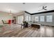 Open-concept living room with hardwood floors, comfortable seating, and large sliding door to the balcony at 10809 Garden Mist Dr Dr # 2041, Las Vegas, NV 89135