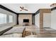 Stylish living space featuring a brick wall, wood floors, and white wood accents at 10809 Garden Mist Dr Dr # 2041, Las Vegas, NV 89135